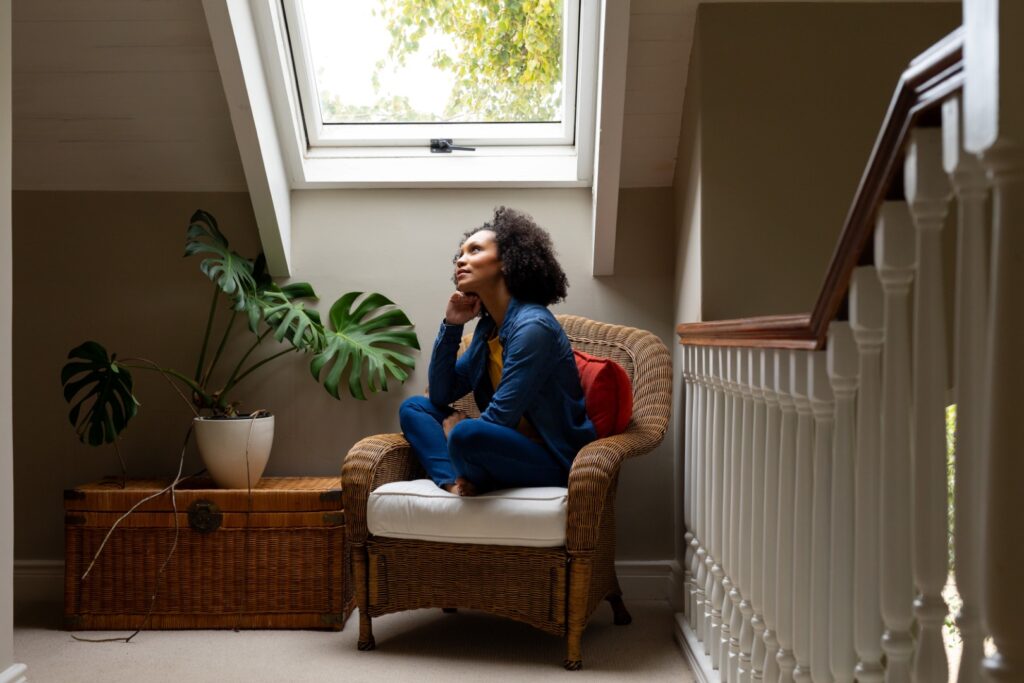 thoughtful biracial woman looking out roof window 2025 04 03 13 15 10 utc